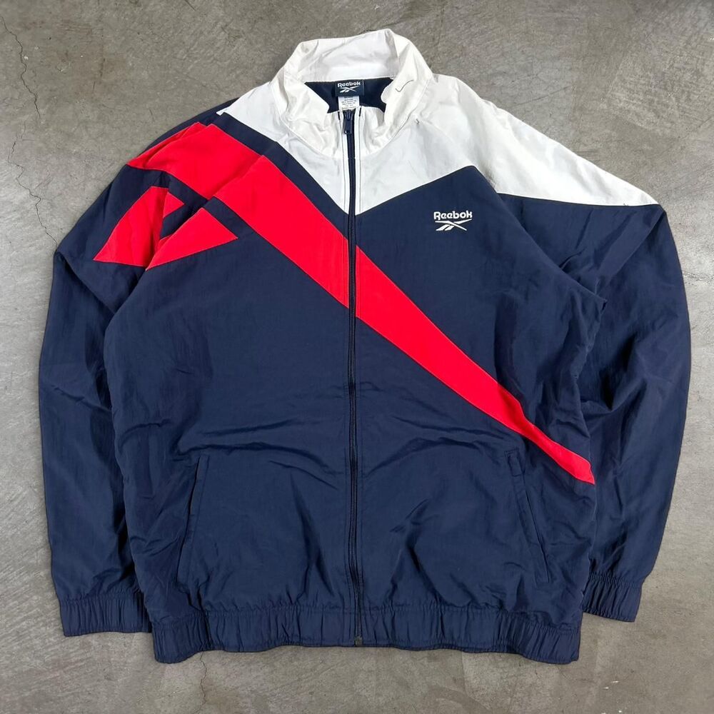 Y2K Reebok navy blue windbreaker with red diagonal stripe and white panel